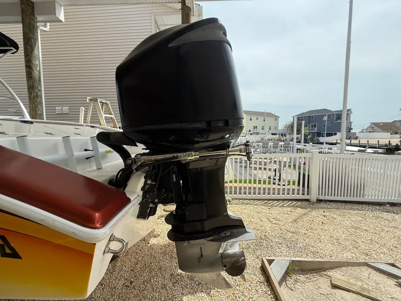 Slide: The Image of 2007 Carrera Boats 36 Center Console with powerful outboard motor, docked in a marina. - 42