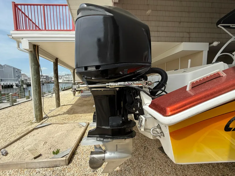 Slide: The Image of 2007 Carrera Boats 36 Center Console with outboard motor, docked near waterfront homes. - 43