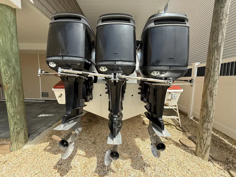 Slide: The Image of 2007 Carrera Boats 36 Center Console with triple outboard engines, rear view. - 44