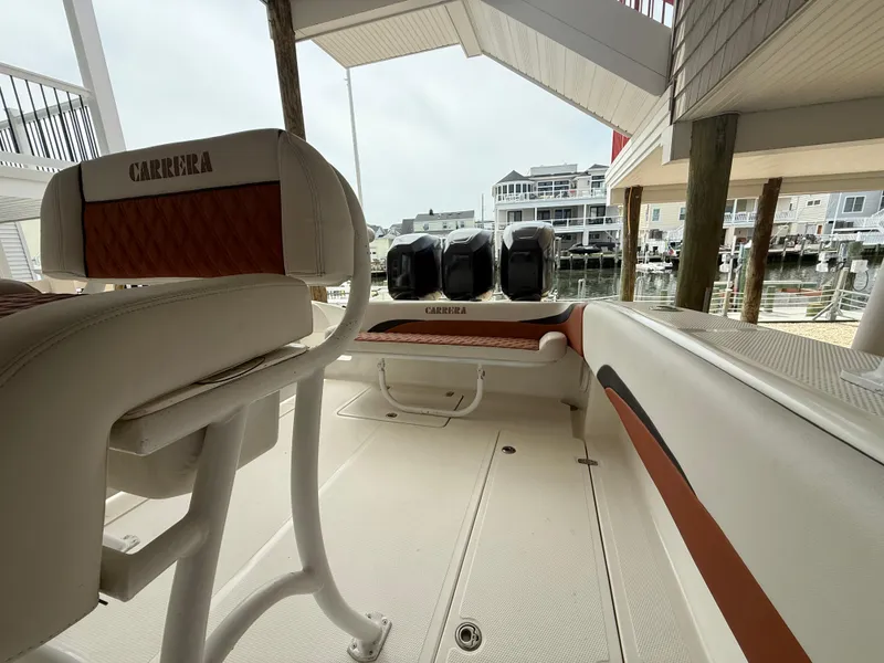 Slide: The Image of 2007 Carrera Boats 36 Center Console interior with seating and triple outboard engines. - 46