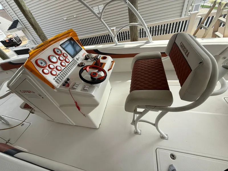 Slide: The Image of 2007 Carrera Boats 36 Center Console helm with modern controls and cushioned seating. - 47