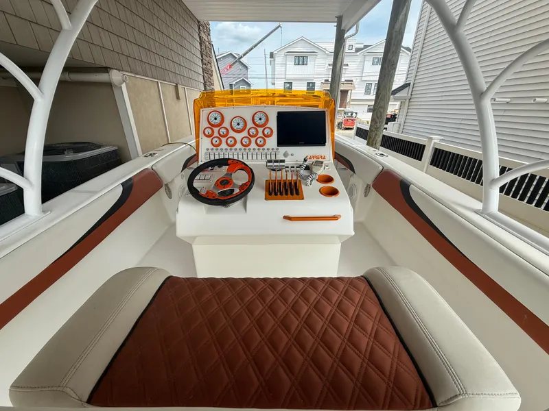 Slide: The Image of 2007 Carrera Boats 36 Center Console with modern dashboard and seating in a residential setting. - 7
