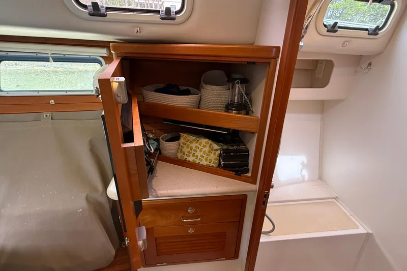 Slide: The Image of Cabinet interior on 2016 MJM 40z Downeast boat, featuring organized storage shelves. - 54