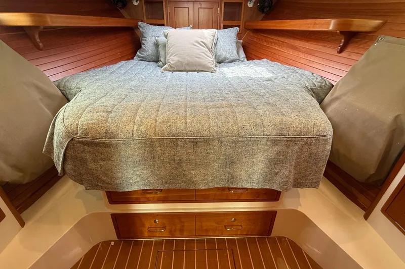 Slide: The Image of Cozy cabin interior of 2016 MJM 40z Downeast with wooden accents and comfortable bedding. - 41