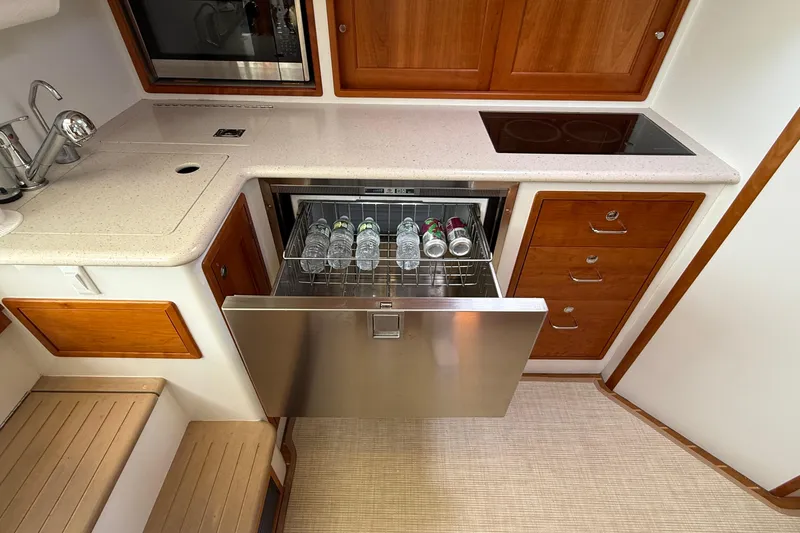 Slide: The Image of Galley of 2016 MJM 40z Downeast yacht with open drawer fridge and countertop. - 32