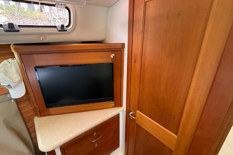 Slide: The Image of Interior of 2016 MJM 40z Downeast yacht with wooden cabinetry and mounted TV. - 52