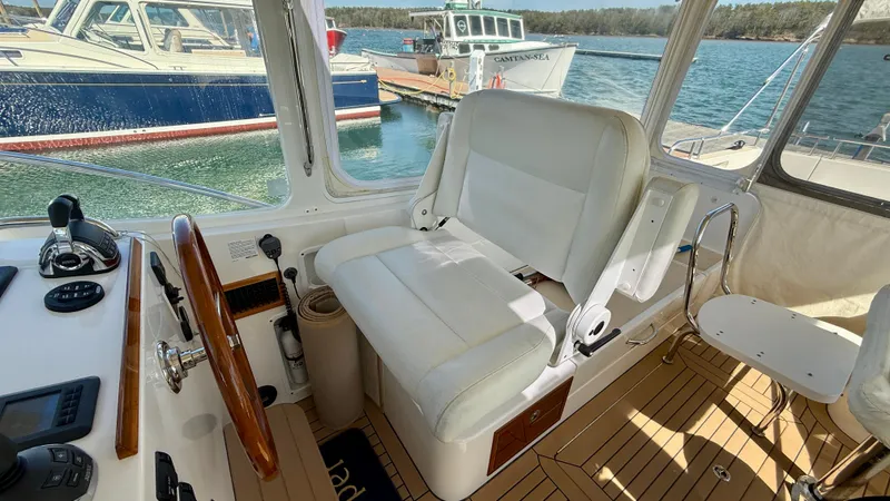 Slide: The Image of Interior of a 2016 MJM 40z Downeast with white seating and wood accents. - 18