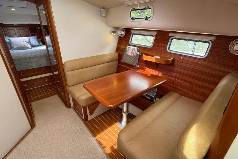 Slide: The Image of 2016 MJM 40z Downeast yacht interior with cozy dining area and wood paneling. - 20