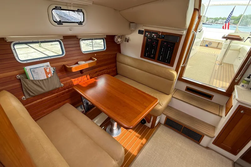 Slide: The Image of Interior of 2016 MJM 40z Downeast yacht with wooden dining area and beige seating. - 25