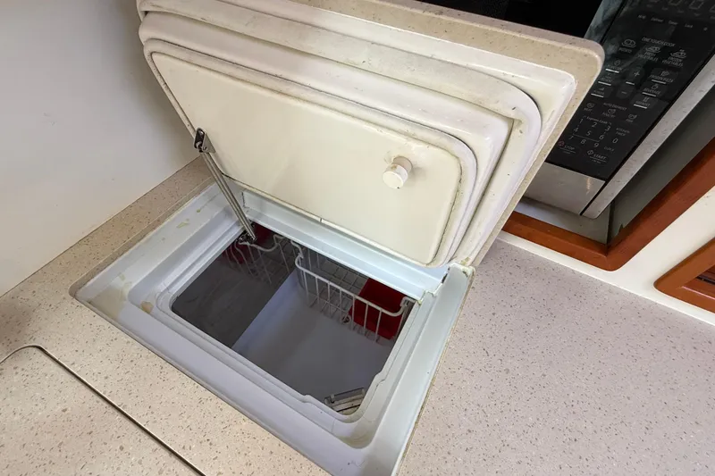 Slide: The Image of Open freezer compartment on 2016 MJM 40z Downeast boat, with visible interior and countertop. - 40