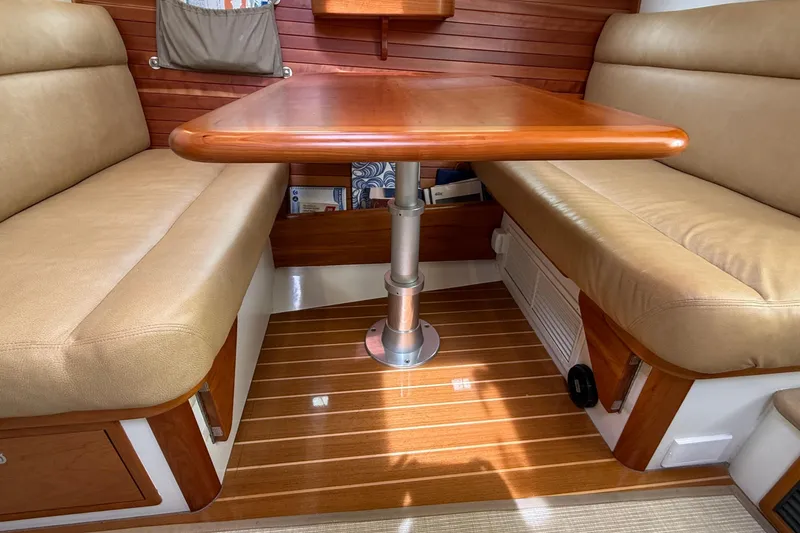 Slide: The Image of Interior of 2016 MJM 40z Downeast yacht with wooden table and beige seating. - 22