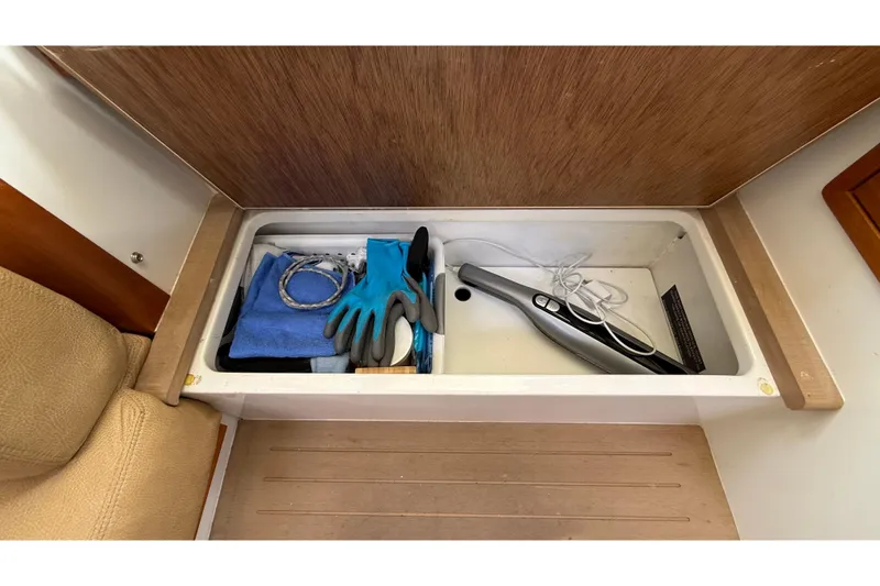 Slide: The Image of Storage compartment in 2016 MJM 40z Downeast boat with gloves and cleaning tools. - 62