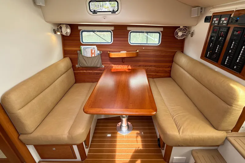 Slide: The Image of Interior of 2016 MJM 40z Downeast yacht with wood table and beige seating. - 21