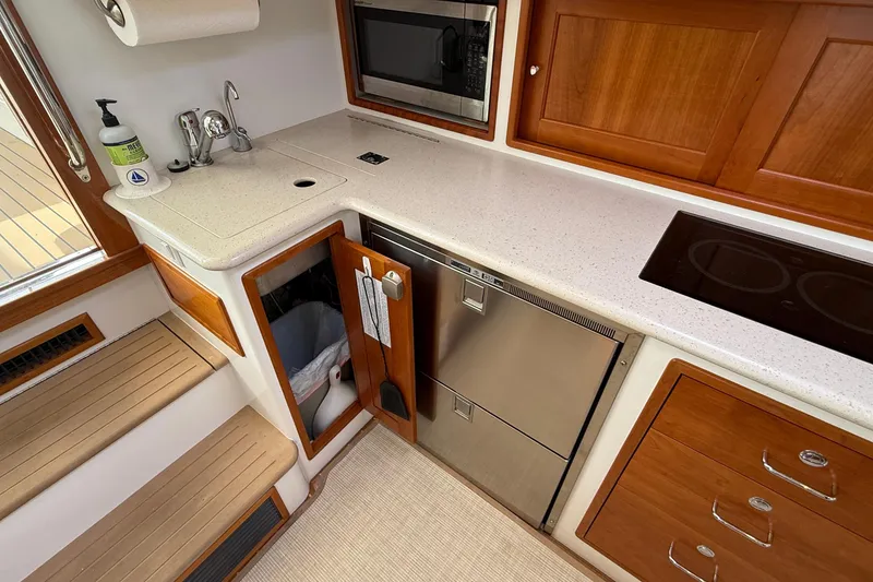 Slide: The Image of 2016 MJM 40z Downeast yacht galley with sink, microwave, and induction cooktop. - 34