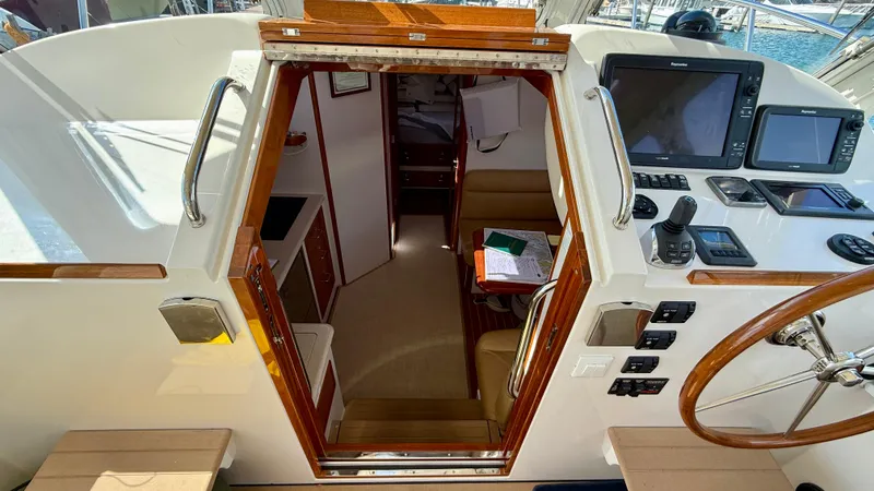Slide: The Image of View into the cabin of a 2016 MJM 40z Downeast with navigation equipment. - 19