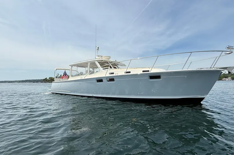 Slide: The Image of 2016 MJM 40z Downeast yacht cruising on calm waters under a clear sky. - 1