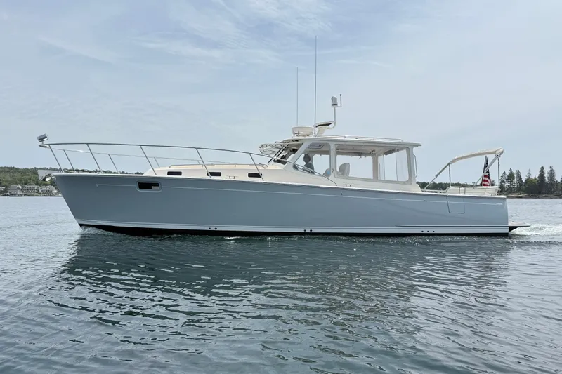 Slide: The Image of 2016 MJM 40z Downeast yacht cruising on calm waters under a clear sky. - 5