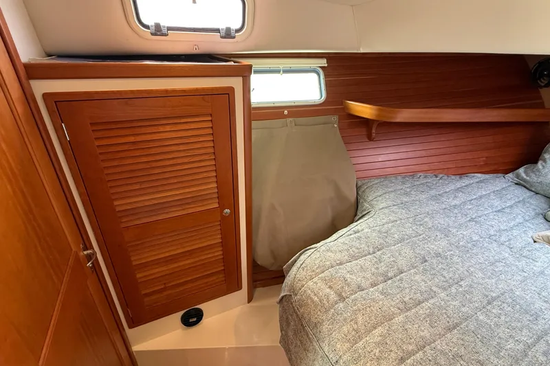 Slide: The Image of Cozy cabin interior of 2016 MJM 40z Downeast with wooden paneling and comfortable bedding. - 46