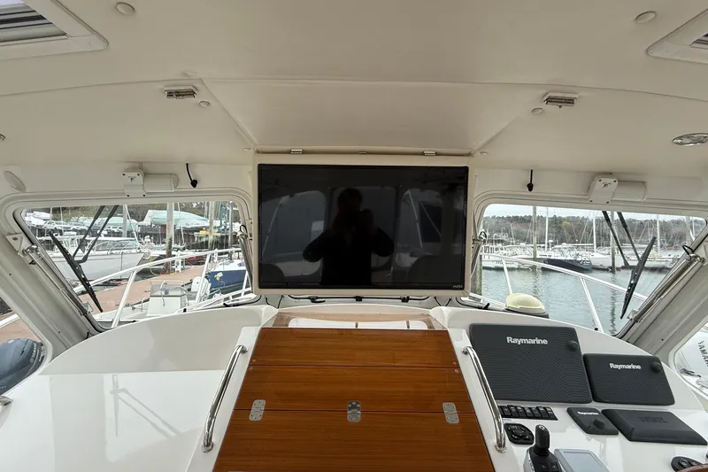 Slide: The Image of Helm of 2016 MJM 40z Downeast yacht with Raymarine electronics and marina view. - 12