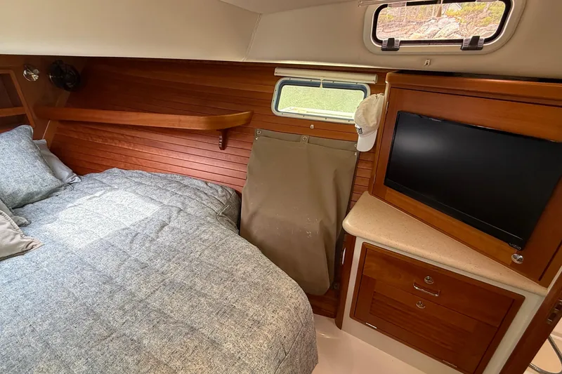 Slide: The Image of Cozy cabin interior of 2016 MJM 40z Downeast with bed, TV, and wooden accents. - 56