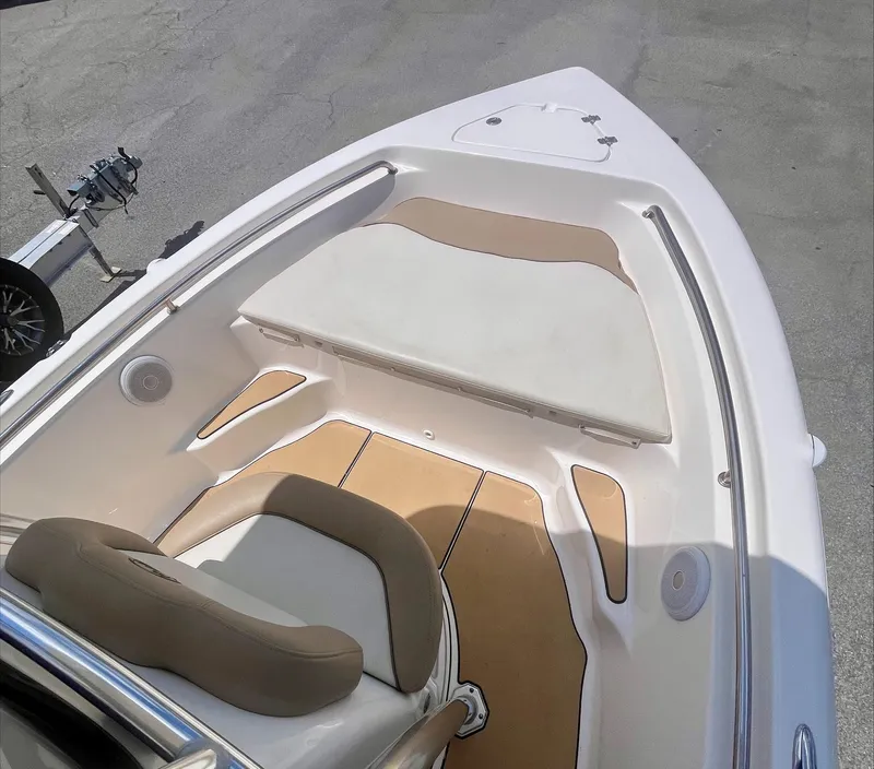 Slide: The Image of 2020 Key West 189 FS boat interior with cushioned seating and tan flooring. - 11