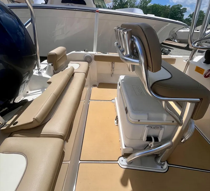 Slide: The Image of 2020 Key West 189 FS boat interior with tan seating and cooler. - 12