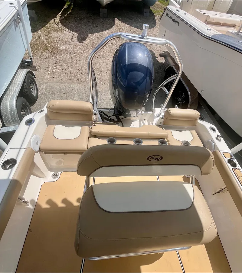 Slide: The Image of 2020 Key West 189 FS boat interior with seating and outboard motor. - 13