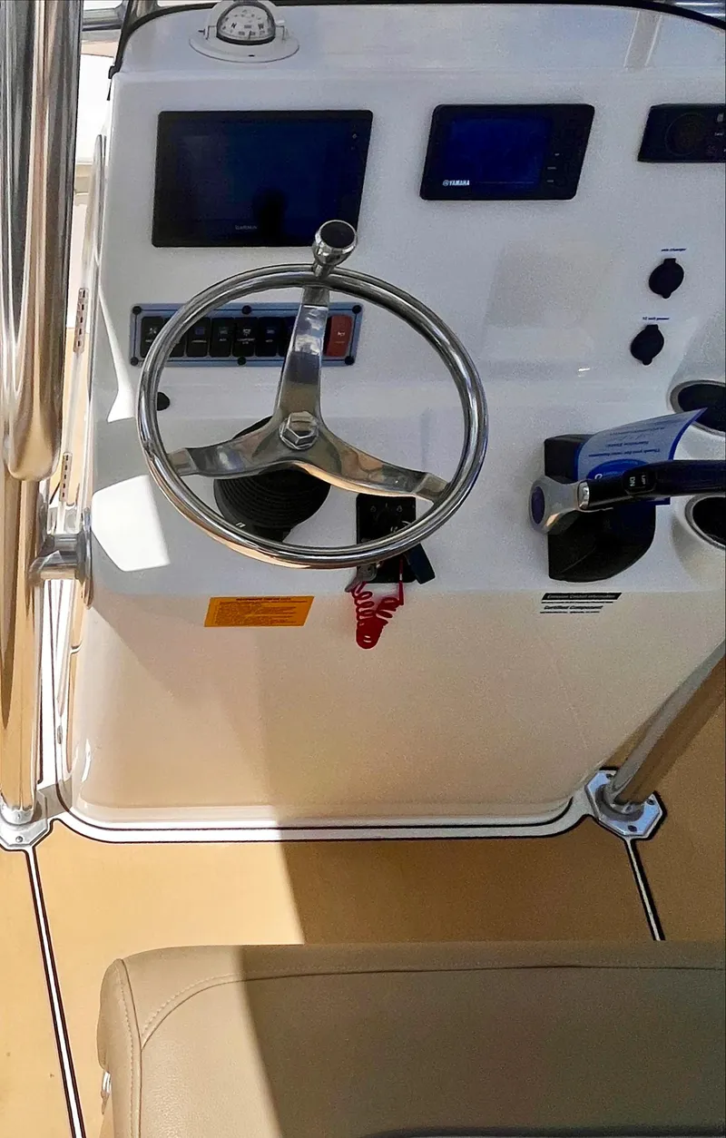 Slide: The Image of 2020 Key West 189 FS boat console with steering wheel and controls. - 14