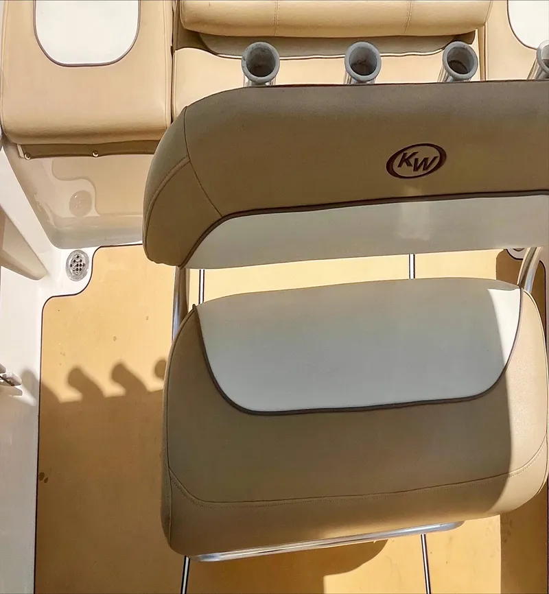 Slide: The Image of 2020 Key West 189 FS boat interior with beige seating and rod holders. - 15