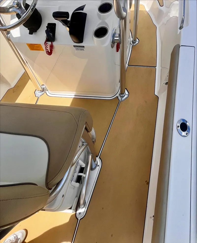 Slide: The Image of 2020 Key West 189 FS boat interior with beige seating and console. - 18