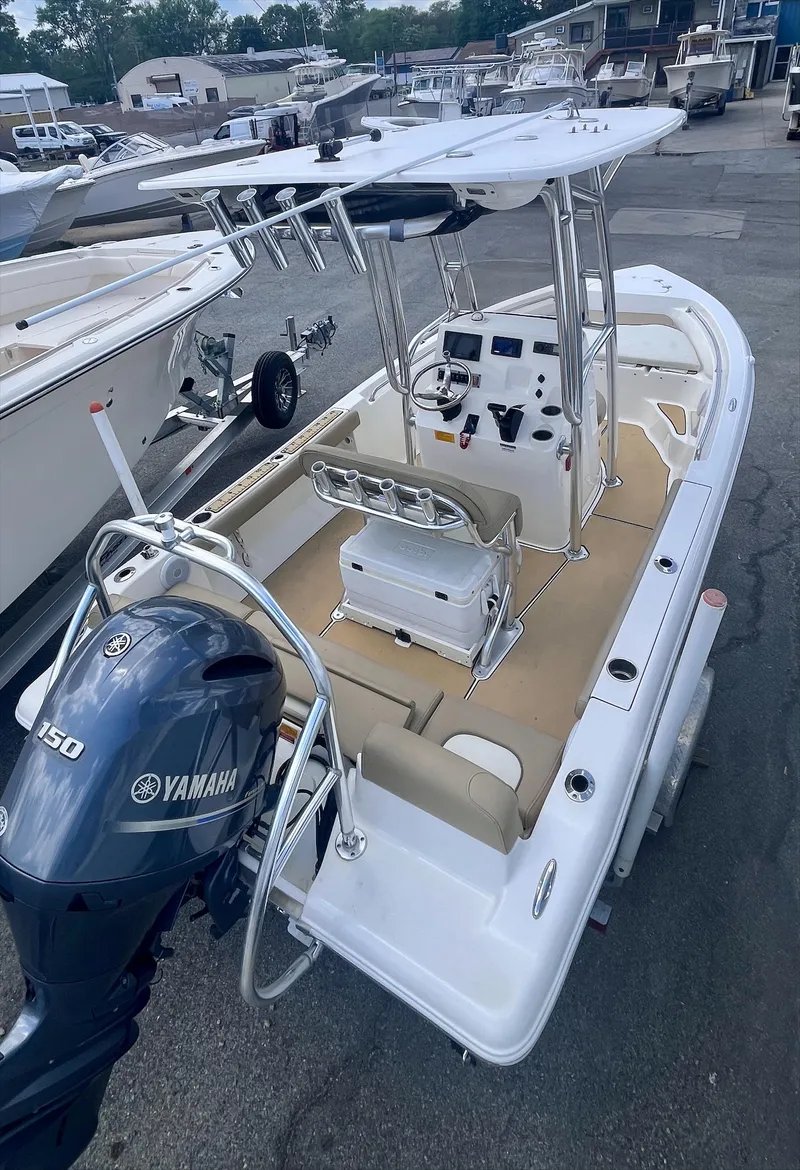 Slide: The Image of 2020 Key West 189 FS boat with Yamaha engine, docked in a marina. - 2