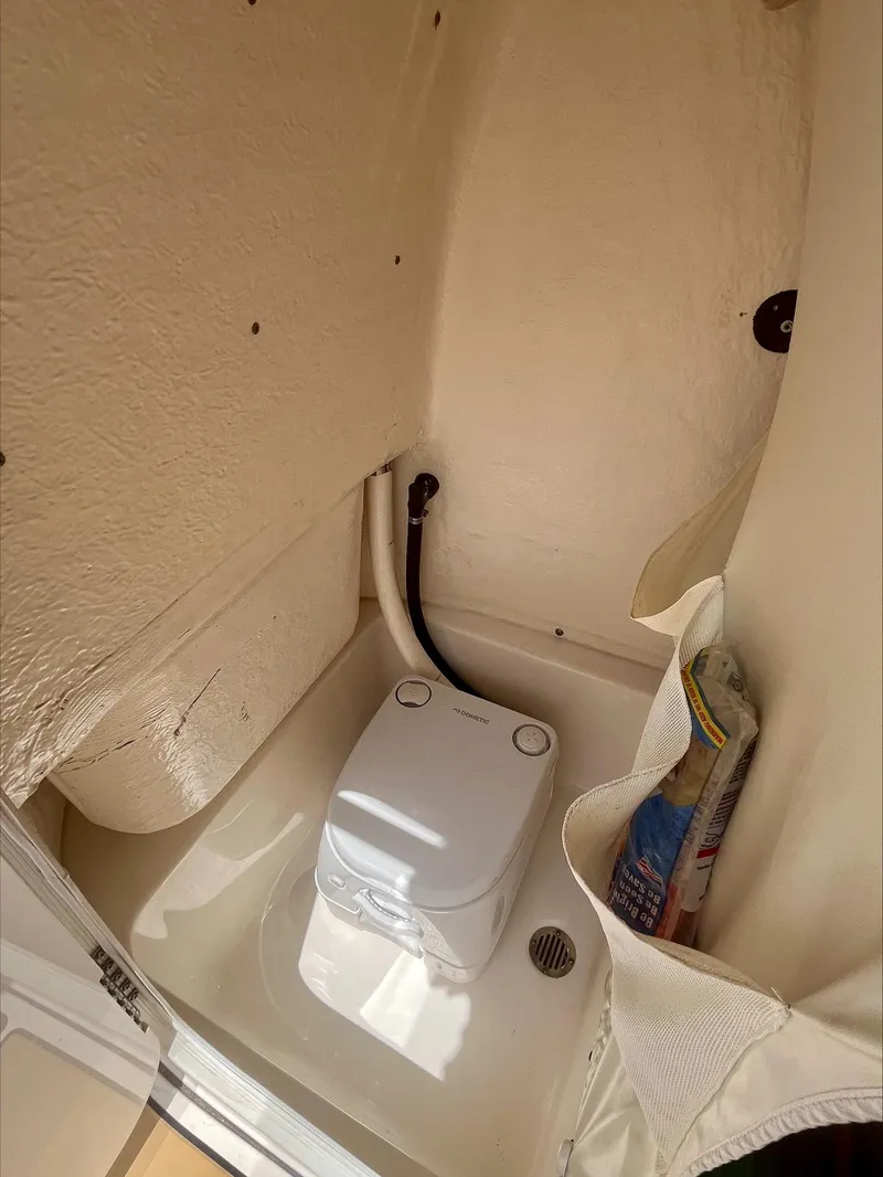 Slide: The Image of 2020 Key West 189 FS boat interior with compact portable toilet. - 20