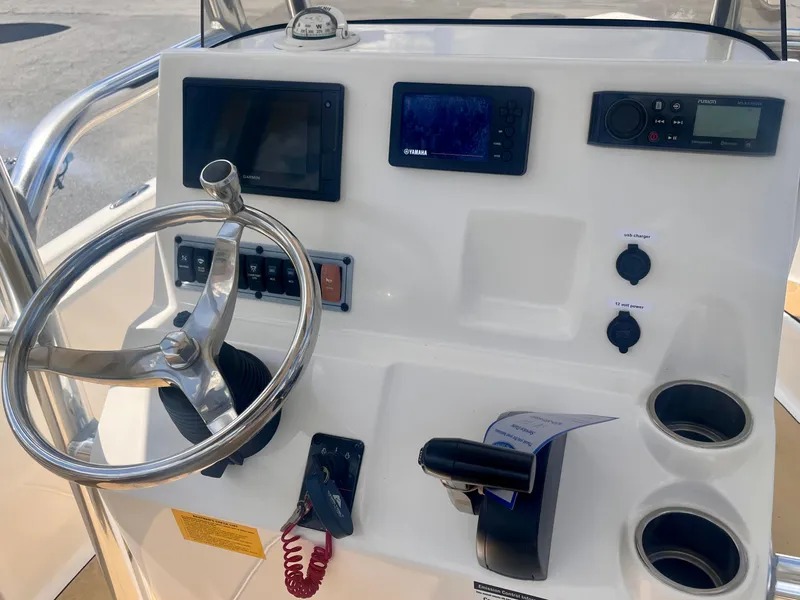 Slide: The Image of 2020 Key West 189 FS boat dashboard with steering wheel, controls, and electronic displays. - 4