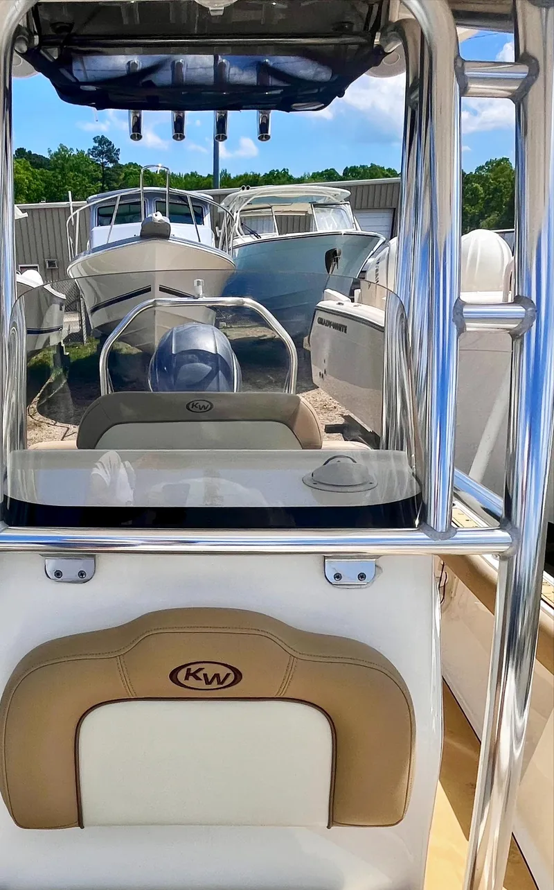 Slide: The Image of 2020 Key West 189 FS boat with sleek design, parked among other boats. - 7