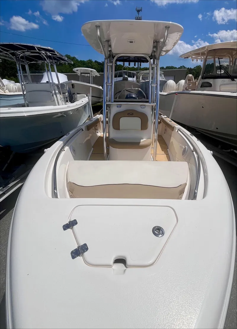 Slide: The Image of 2020 Key West 189 FS boat with T-top, docked under a clear blue sky. - 9