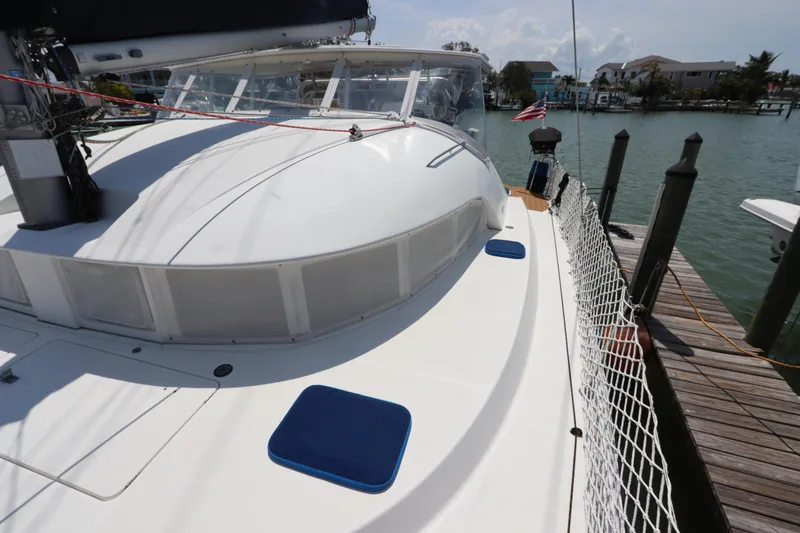 Slide: The Image of Lagoon 380 catamaran docked, showcasing deck and cabin, 2001 model. - 14