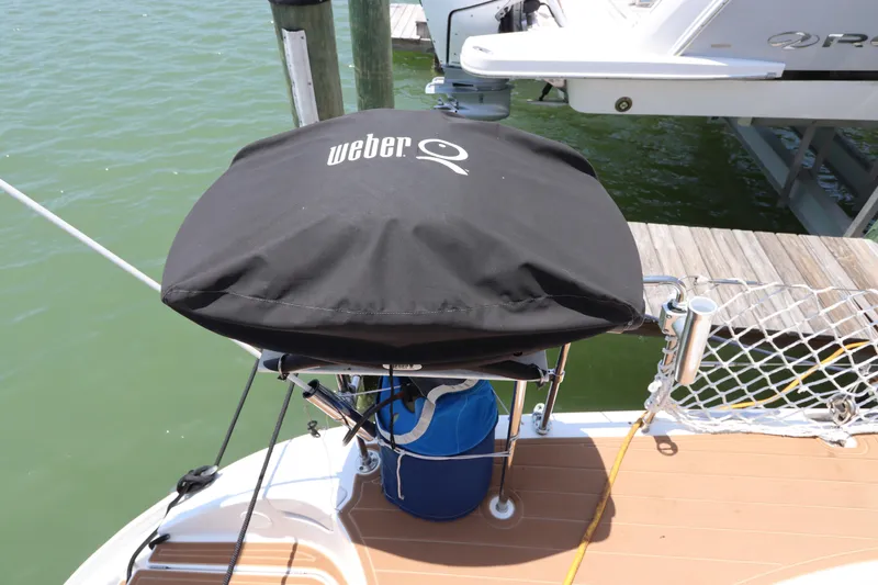 Slide: The Image of Weber grill on Lagoon 380 catamaran deck, 2001 model, docked by water. - 21