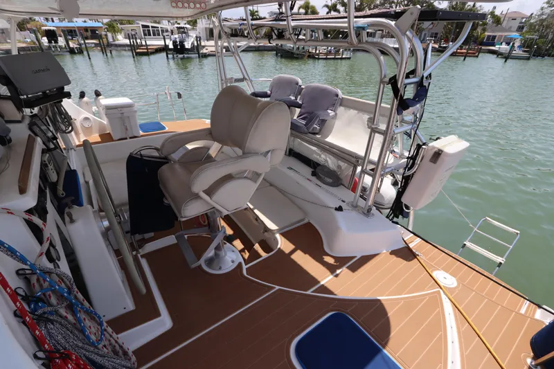 Slide: The Image of Lagoon 380 catamaran cockpit with seating, ropes, and water view, 2001 model. - 26