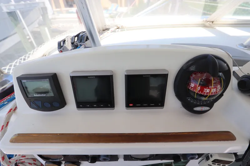 Slide: The Image of Control panel of a 2001 Lagoon 380 catamaran with navigation instruments and compass. - 31