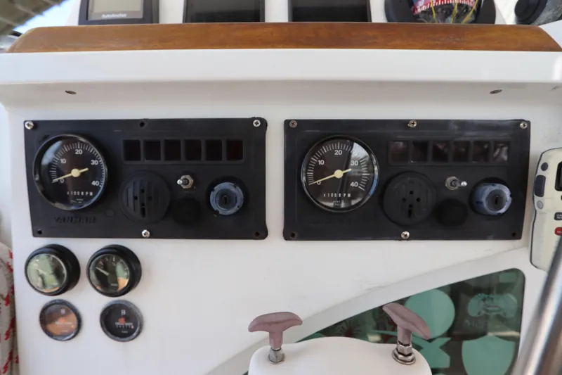 Slide: The Image of Control panel of a 2001 Lagoon 380 catamaran with gauges and dials. - 32