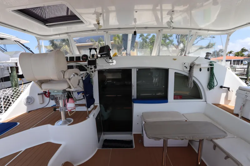 Slide: The Image of Interior view of a 2001 Lagoon 380 catamaran, featuring helm and seating area. - 34
