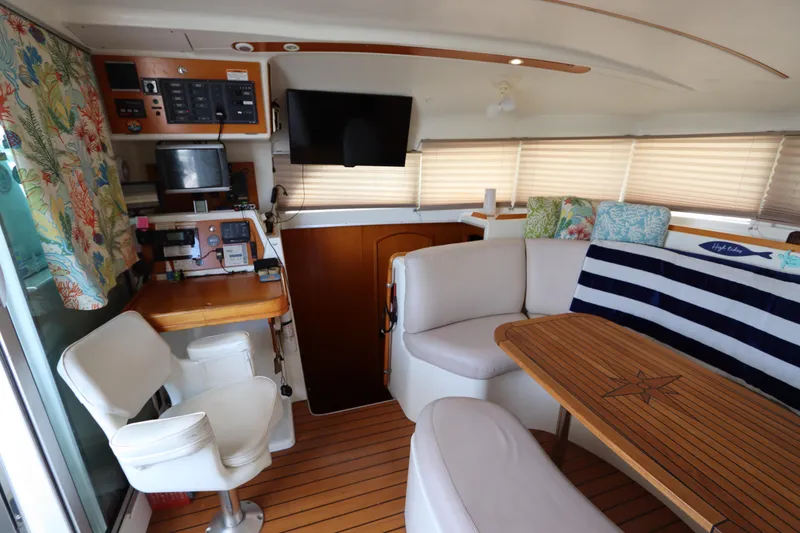 Slide: The Image of Interior of 2001 Lagoon 380 catamaran with seating, table, and navigation equipment. - 38