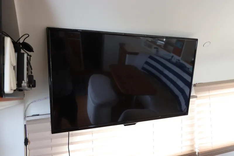 Slide: The Image of Flat-screen TV mounted on a wall inside a 2001 Lagoon 380 catamaran. - 39