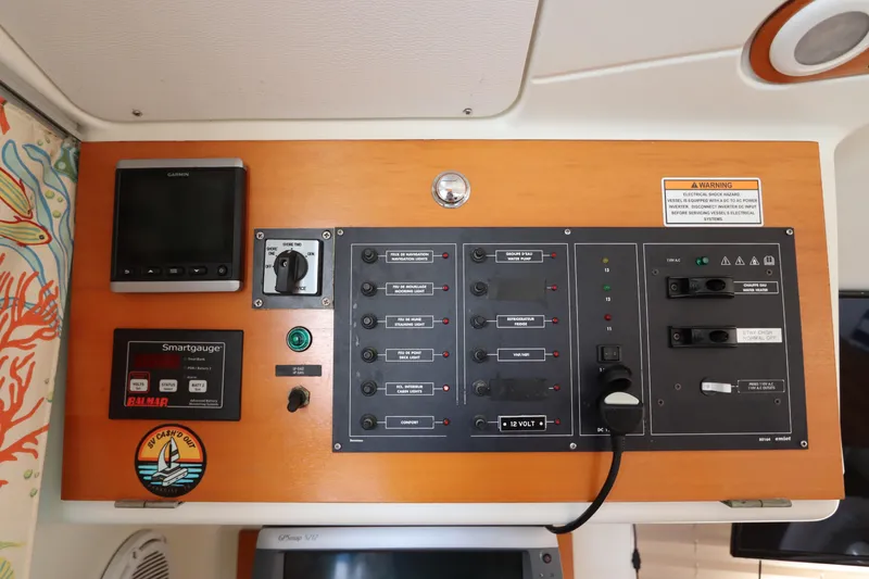 Slide: The Image of Control panel of a 2001 Lagoon 380 catamaran with various switches and displays. - 40
