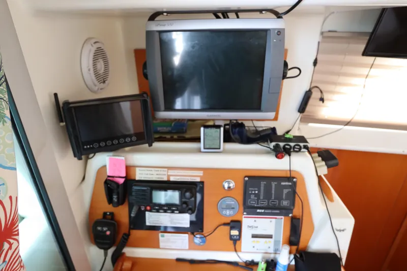 Slide: The Image of Control panel of a 2001 Lagoon 380 catamaran with navigation and communication equipment. - 41