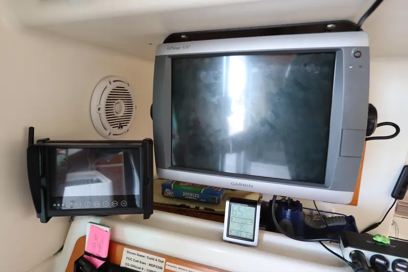 Slide: The Image of Navigation equipment on a 2001 Lagoon 380 catamaran, featuring Garmin displays and controls. - 42