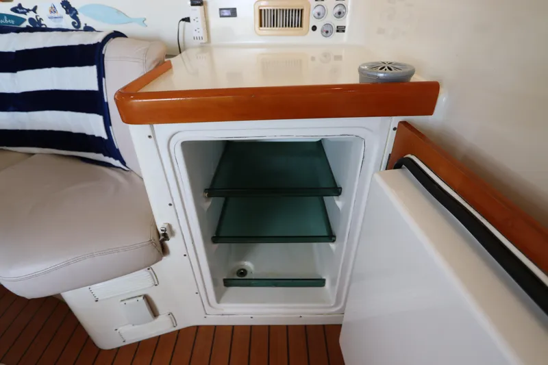 Slide: The Image of Interior of 2001 Lagoon 380 yacht with open mini fridge and seating area. - 47
