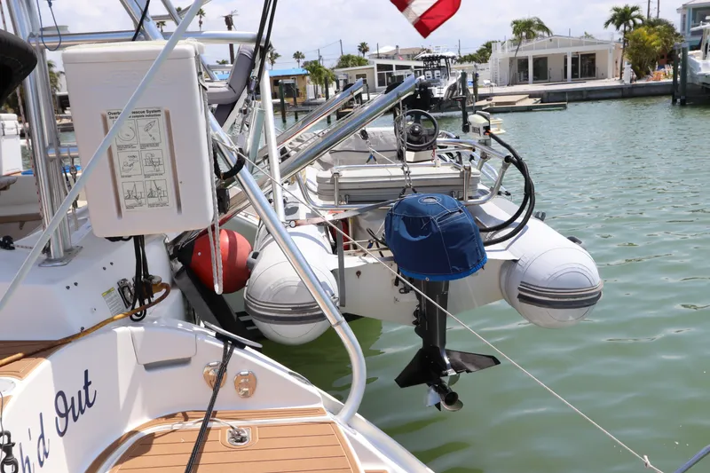 Slide: The Image of Lagoon 380 catamaran, 2001 model, docked with dinghy and equipment, sunny marina setting. - 6