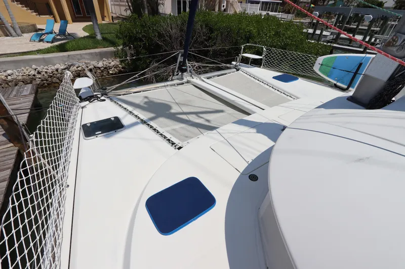 Slide: The Image of Lagoon 380 catamaran deck, 2001 model, featuring netting and seating area. - 7