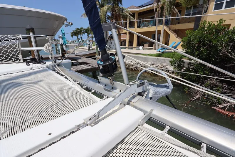 Slide: The Image of Lagoon 380 catamaran docked near waterfront property, showcasing deck and rigging. - 8